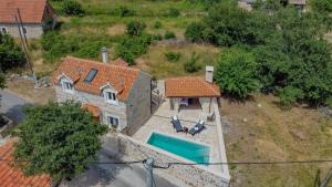 an aerial view of a house with a swimming pool at Villa Mara in Drniš