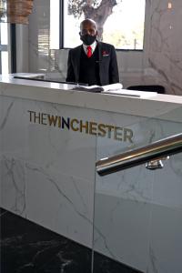 a man wearing a mask sitting at a desk at Rose Gold @The Winchester in Cape Town +61 photos