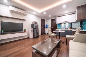 a living room with a television and a kitchen at T&B HOUSING in Hanoi