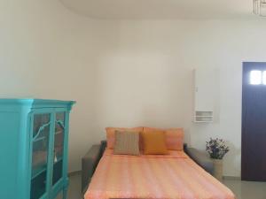 a bedroom with a bed and a blue cabinet at Coco' Country House Lecce in Lecce