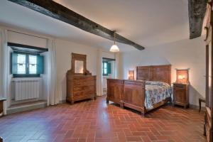 a bedroom with a bed and two dressers and a mirror at Castello di Sarna in Chiusi della Verna +113 photos