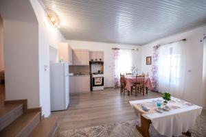a living room with a table and a kitchen at Casa di levante - Glossa Skopelos in Loutraki