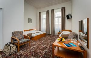 a hotel room with a bed and a living room at City Centre in Prague