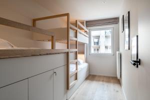a small room with a bunk bed and a window at - Maja - Peaceful luxurious appt near the beach in Koksijde in Koksijde