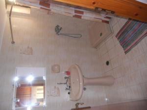 a bathroom with a mirror and a toilet in it at Assimakis Hotel in Finikounta +28 photos