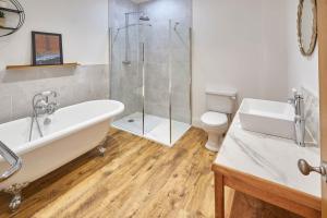 a bathroom with a tub and a toilet and a shower at Host & Stay - Burnsyde Beach House in Saltburn-by-the-Sea