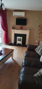 a living room with a couch and a fireplace at Courthouse View in Carrick on Shannon