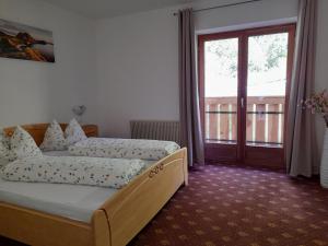 a bedroom with a bed and a sliding glass door at Stuberhof in Rifiano