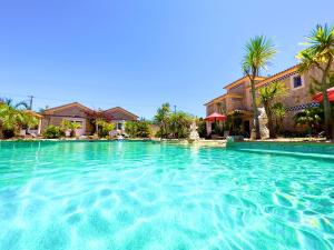 a large pool of water in front of a house at Quinta do Mar - Country & Sea Village in Luz