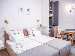 a small bedroom with a bed and a table at Pinna Apartments Hvar in Hvar