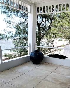 a vase sitting on a porch with a view of the water at Baan Soulmates in Ban Khung Tanot
