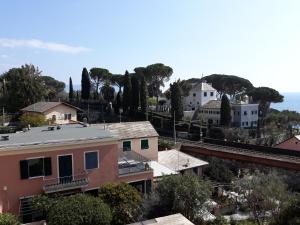 a view of a town with houses and the ocean at House Orizzonte - Casa Bianca in Genoa