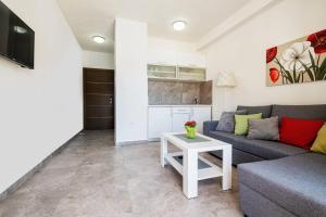 a living room with a couch and a table at Apartmani Divna in Neum