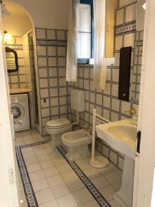 a bathroom with a toilet and a sink at Isola - LIPARI centro storico in Lipari