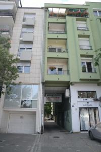 an empty street in front of a building at Apartment DobraYa Blue in Novi Sad