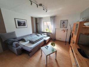 a living room with a couch and a table at Ferienwohnung Baumann in Neupotz