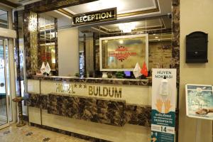 a restaurant with a reception counter in a building at Buldum Otel in Ankara