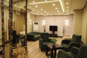 a living room with couches and a flat screen tv at Buldum Otel in Ankara
