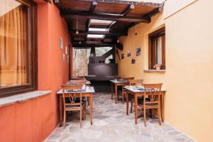 a row of tables and chairs in a restaurant at Alkifron Hotel in Kala Nera