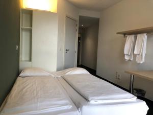 Ein Bett oder Betten in einem Zimmer der Unterkunft The ASH