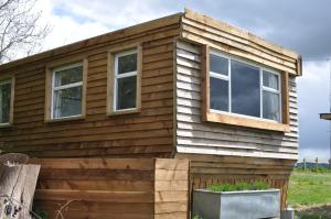 a house with windows on the side of it at Cosy and rural Lodge at Goldhill Glamping in Shaftesbury