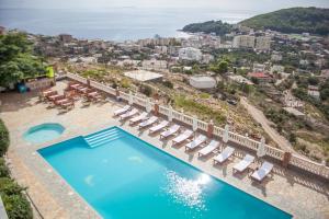 an aerial view of a resort with a pool and lounge chairs at Lovely Sea View Apartments & Junior Suites in Himare