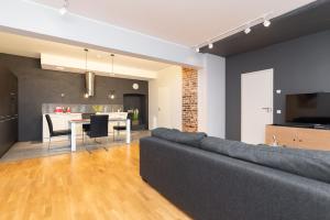 a living room with a couch and a dining room at Stylish apartment with parking in Telliskivi in Tallinn