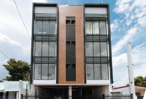 a tall brick building with large windows at RedDoorz at Good 101 Paranaque in Manila