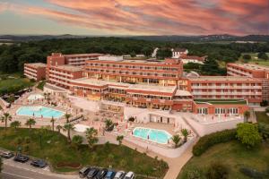 an aerial view of a resort with two pools at Hotel Albatros Plava Laguna in Poreč