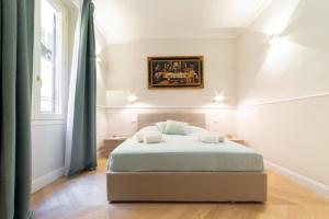 a bedroom with a bed with a painting on the wall at Altafronte Enchanted Suite close to Uffizi Gallery in Florence