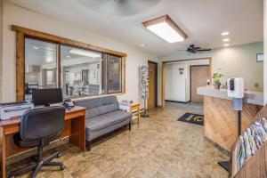 an office with a couch and a desk with a computer at Econo Lodge, Downtown Custer Near Custer State Park and Mt Rushmore in Custer