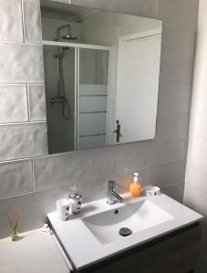 a bathroom with a white sink and a mirror at Lo Pagan Beachfront Aircon Apartment in San Pedro del Pinatar