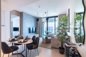 a living room with a table and chairs and a couch at The Smart Concierge - Address JBR in Dubai