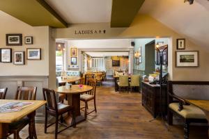 a restaurant with tables and chairs and a dining room at Inn in the Park in Bournemouth