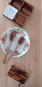 a table with two wooden spoons on a plate at Marina Piccola Apartment in Bari