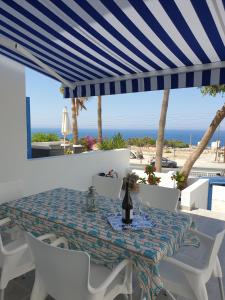 a dining table with a view of the beach at Ikaria Village Maisonette 12 in Paphos