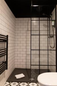 a bathroom with a glass shower and a sink at The Baltic Hotel in Liverpool