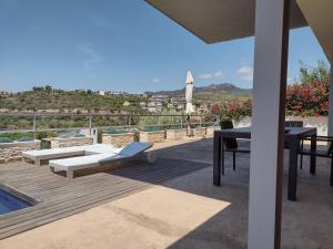 un patio con mesa, sillas y piscina en CasadelaLuzBenicasim, diseño y lujo, en Oropesa del Mar