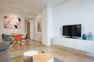 a living room with a flat screen tv on a wall at San Bernardo Boutique - Free Parking in Seville