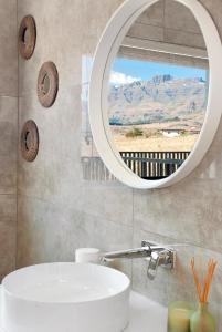 a bathroom with a sink and a mirror at Eleven on Tumbleweed, Cathkin Estates in Champagne Valley