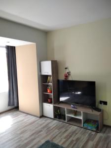 a living room with a flat screen tv and a entertainment center at ТИХОТО МЯСТО in Burgas City