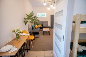 a living room with a table and a couch at Miodowa Zagroda - nocleg Zator Energylandia in Miejsce