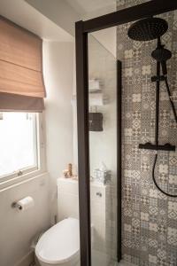 a bathroom with a toilet and a shower at Stone's throw Cottage Mevagissey in Mevagissey