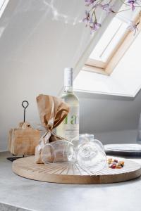 una botella de vino y copas en una tabla de cortar en 99 Lifestyle Suite en Zwaag