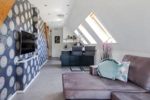 a living room with a couch and a table at 99 Lifestyle Suite in Zwaag