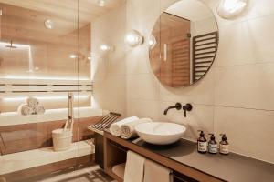 a bathroom with a sink and a mirror at Omaela Apartments in Sankt Anton am Arlberg