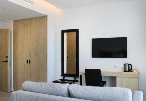 a living room with a couch and a desk at AP Cabanas Beach & Nature - Adults Friendly in Cabanas de Tavira