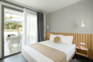 Postel nebo postele na pokoji v ubytování Yuka Villas Collection