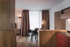 a kitchen and dining room with a table and chairs at Omaela Apartments in Sankt Anton am Arlberg