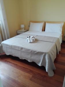 two stuffed animals sitting on top of a bed at Country House Martina in Castelnuovo Berardenga